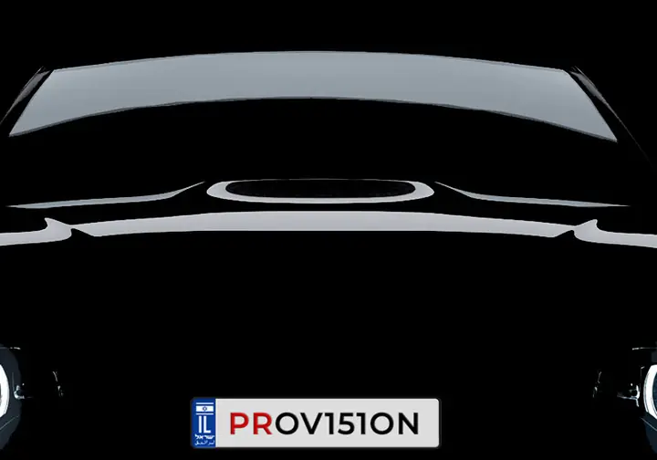 Front of a car with its number plate, seen by a camera at night